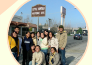 Group of students in front of Little Manila sign in Stockton