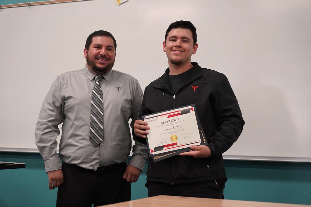 Tesla Instructor with a graduating student