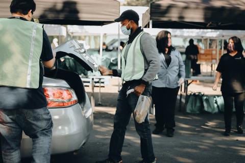 Volunteers loading food supplies to students and community