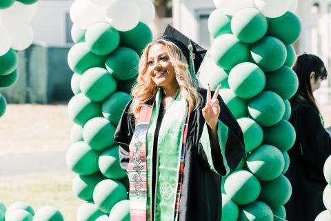 smiling student in cap and gown