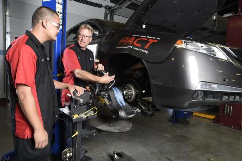 Auto faculty and student working on a car