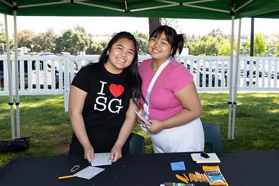 2 female students manning a table at graduation